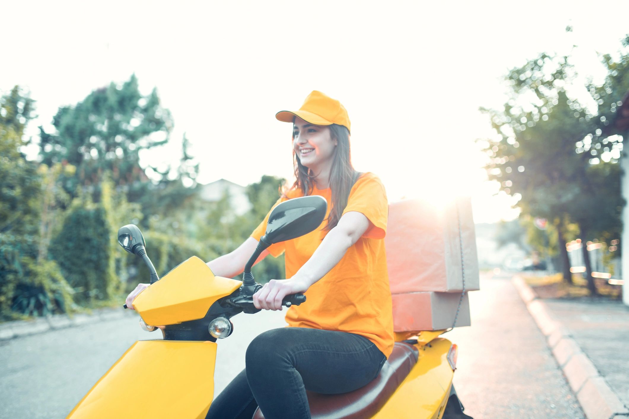 Smiling delivery courier on scooter