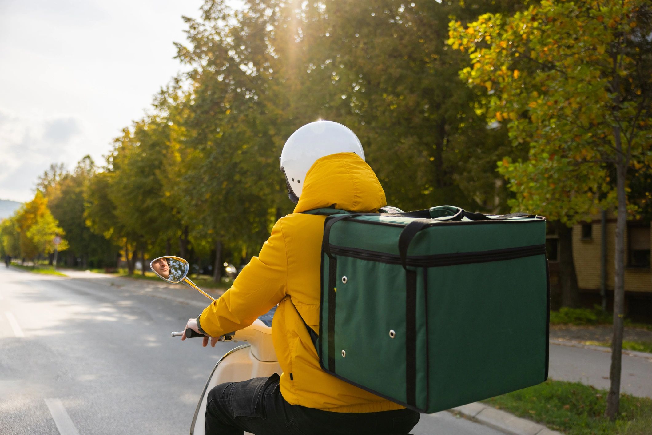Delivery courier riding a scooter in the city